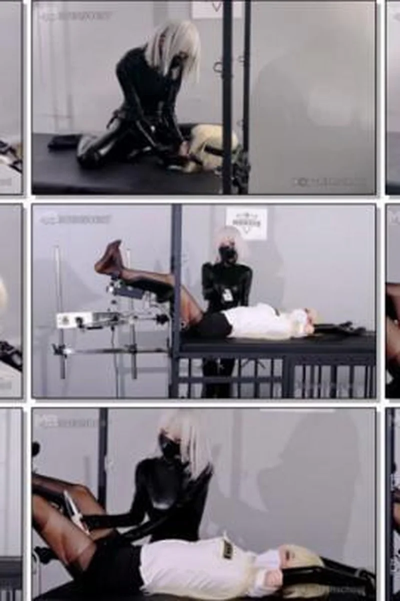 Latex Domme Controls Blonde Officer On Restraint Table